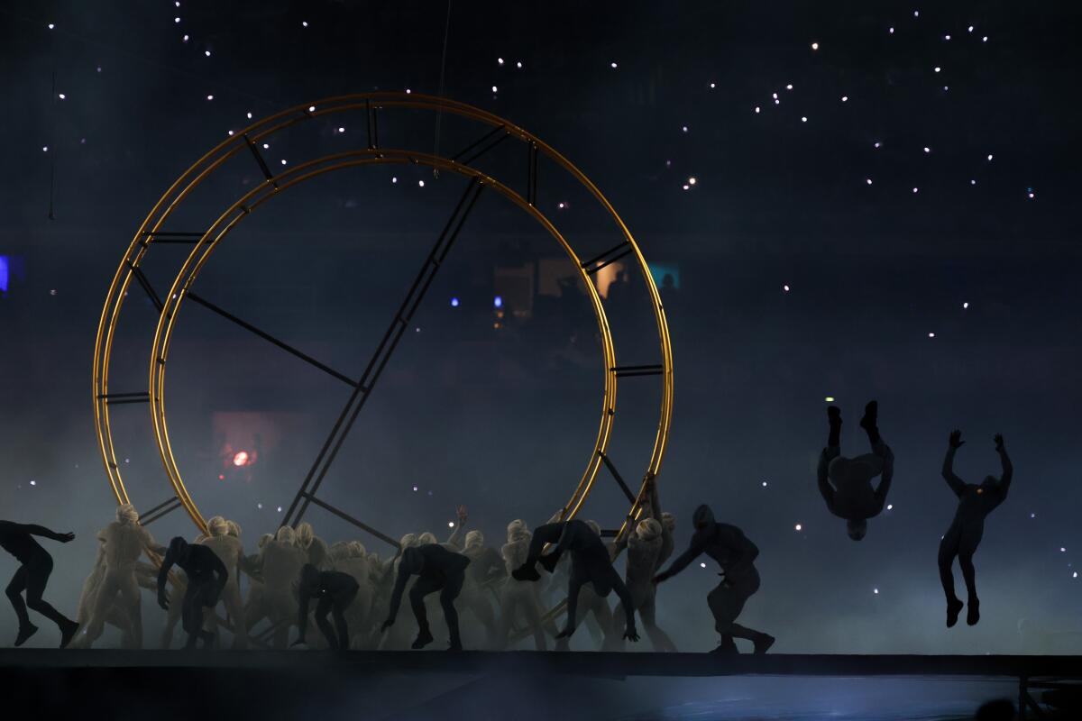 Performers raise rings during the closing ceremony of the 2024 Paris Olympics at Stade de France on Sunday.