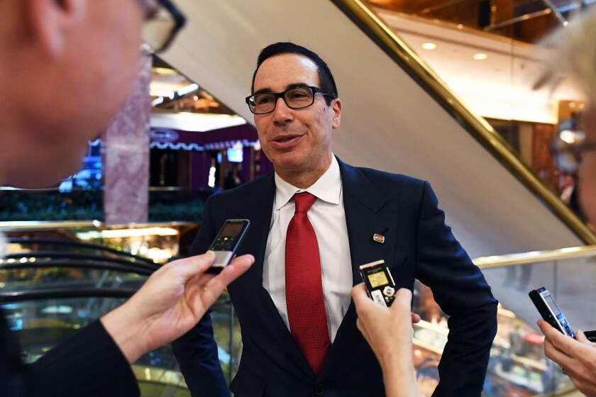 Former Goldman Sachs investment banker Steven Mnuchin speaks to reporters at the Trump Tower in New York.