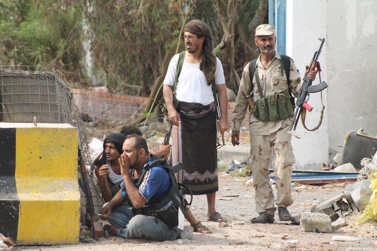 Fighters opposed to Shiite Muslim Houthi rebels gather Thursday along the frontline of fighting in the port city of Aden, Yemen.