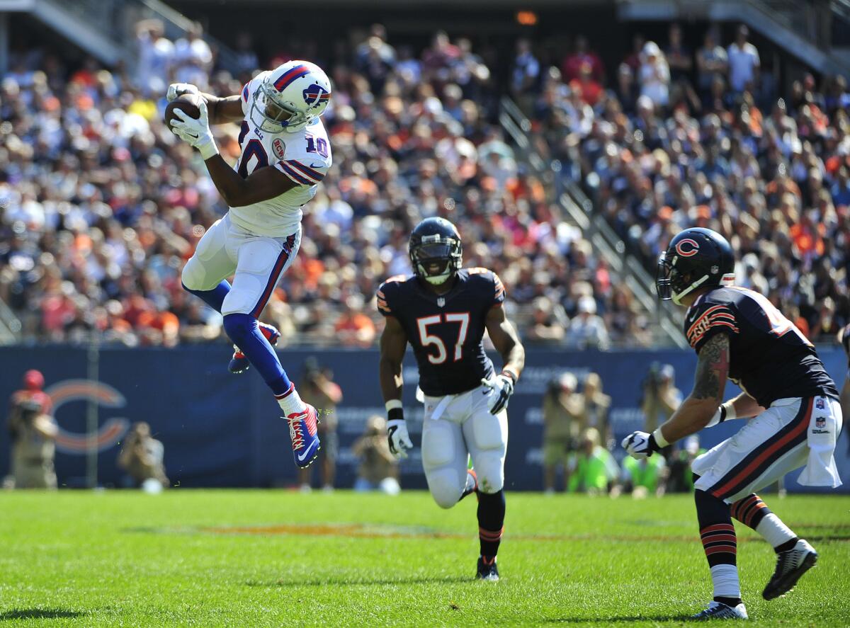 Buffalo's Robert Woods makes a leaping catch in front of Chicago's Jon Bostic and Chris Conte on Sept. 7.