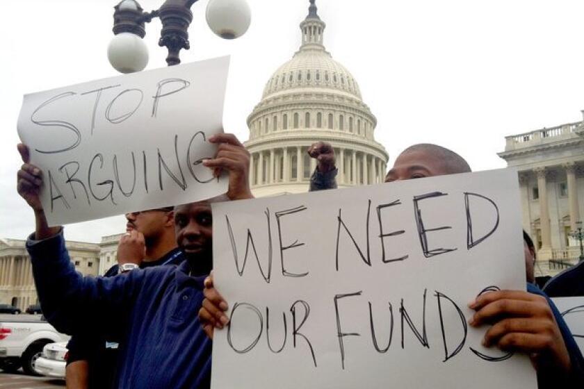 More contractors have announced furloughs due to the prolonged government shutdown. Above, protesters in Washington on Wednesday urged Congress to reopen government agencies and pass a budget.