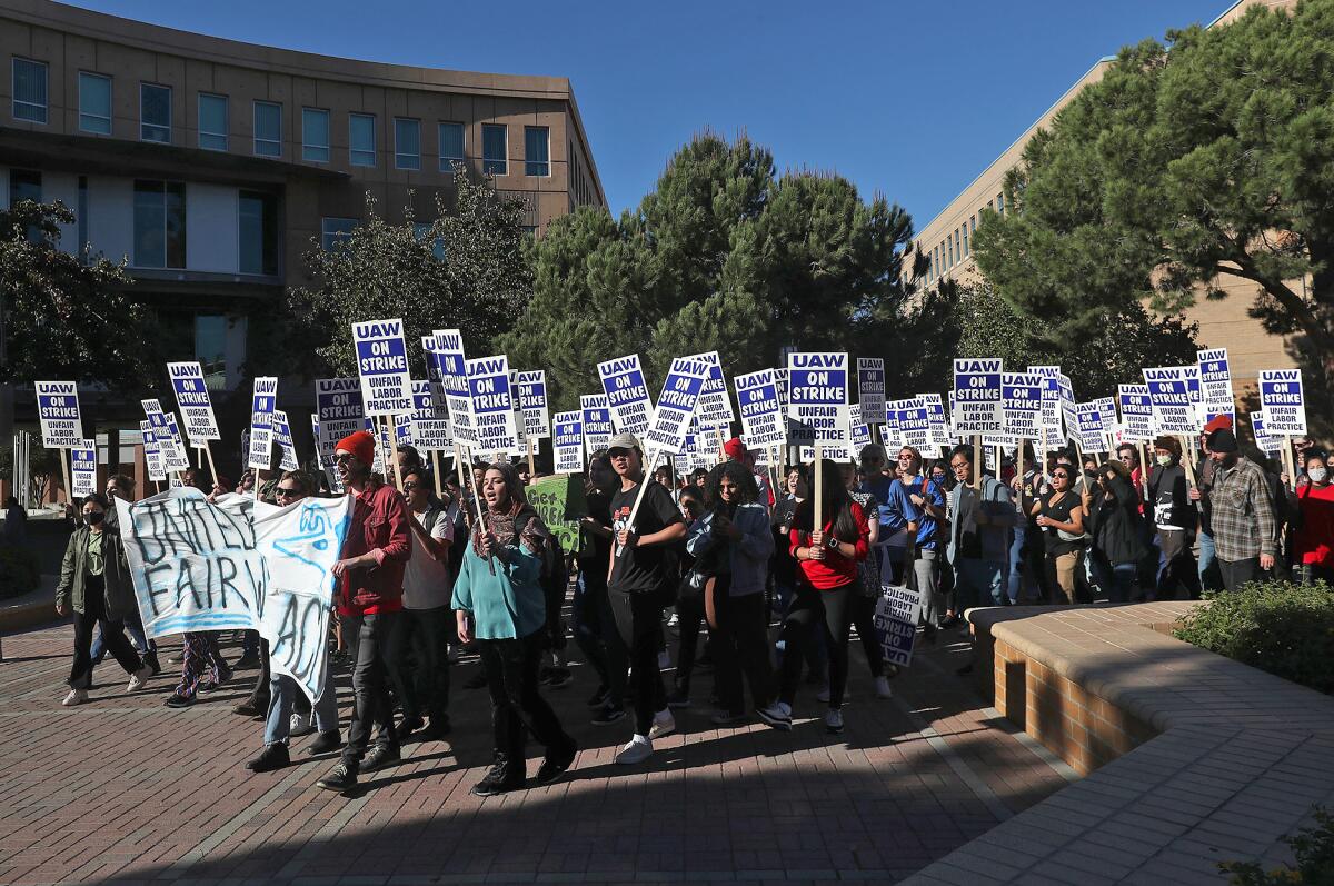 UC Irvine students walk in support of an UC academic workers labor strike that started on Monday.