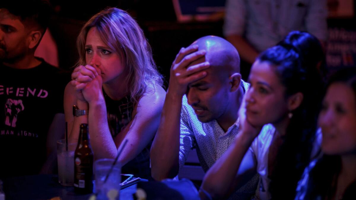 Hillary Clinton supporters react as election returns come during a party at The Abbey, in West Hollywood.