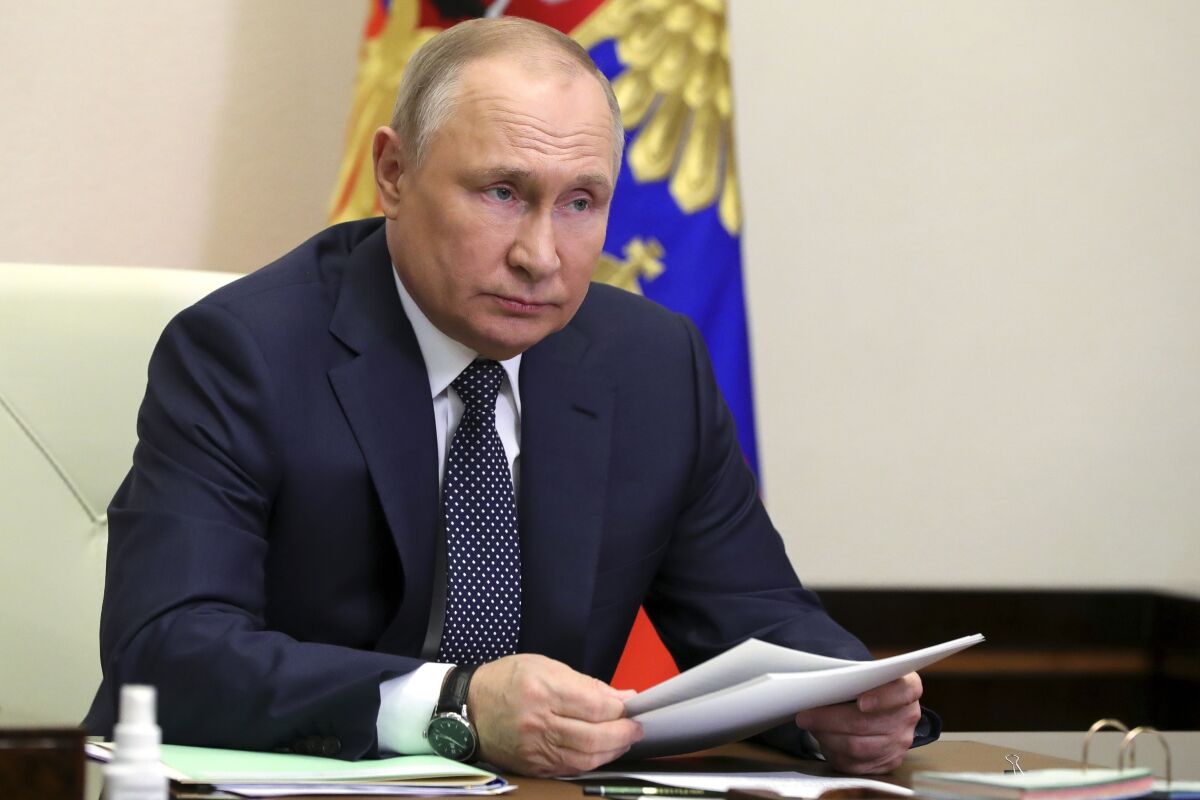 Russian President Vladimir Putin attends a meeting with top officials on support to aviation industry in Russia amid western sanctions vis videoconference at the Novo-Ogaryovo residence outside Moscow, Russia, Thursday, March 31, 2022. (Mikhail Klimentyev, Sputnik, Kremlin Pool Photo via AP)