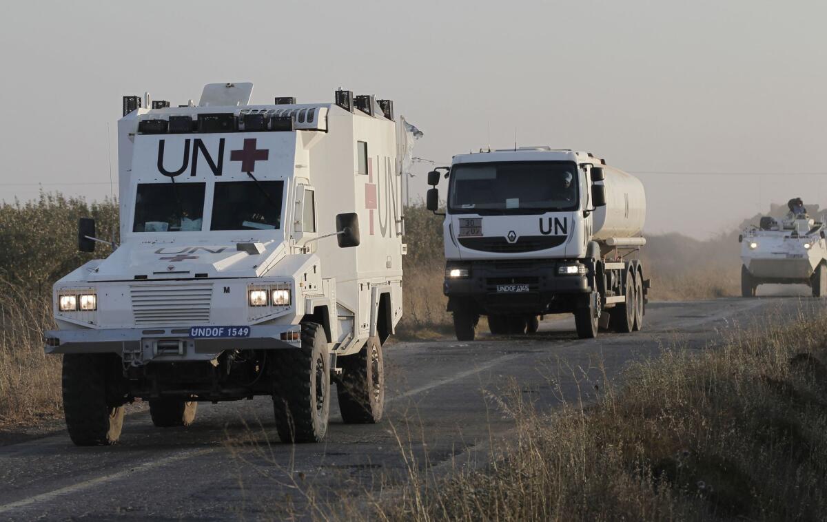 Members of the U.N. Disengagement Observer Force in the Israeli-annexed Golan Heights near the Quneitra crossing between Israel and Syria on Saturday.