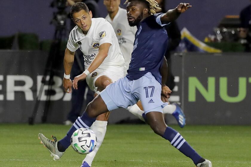 CARSON, CALIF. -MAR. 7, 2020, Javier "Chicharito" Hernandez tajkes a shot against Vancouver defender Leonard Owusu in the second half at Dignity Health Sports Park in Carson on Saturday, Mar. 7, 2020. (Luis Sinco/Los Angeles Times)