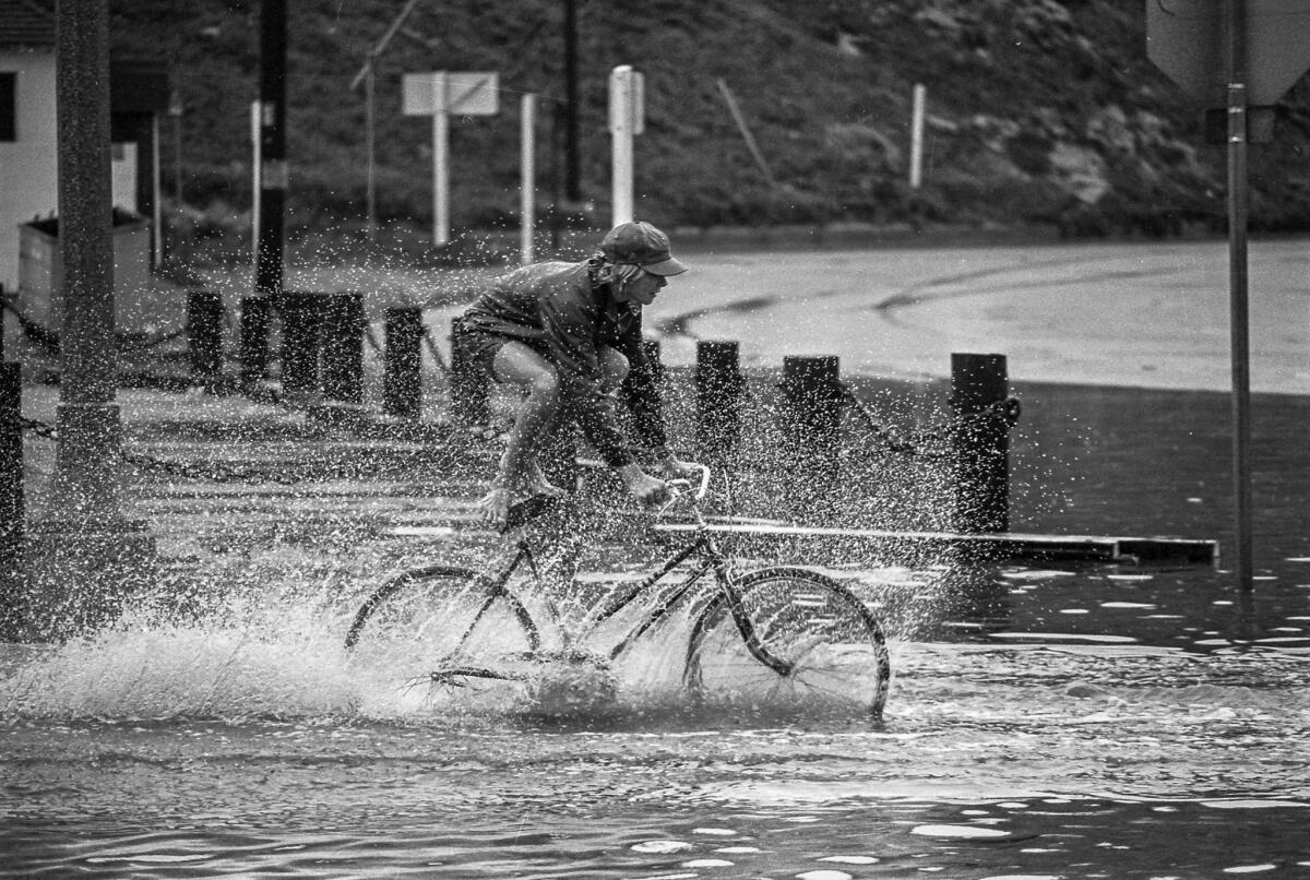 Sept. 10, 1976: A youngster makes the most of the wettest Sept. 10 in local history by gliding a bike through a flooded area at Culver Boulevard and Pacific Avenue in Playa del Rey.