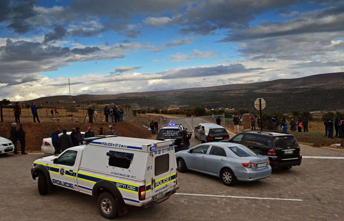 A police convoy and a hearse arrive at Mvezo resort on Wednesday to collect the remains of former South African President Nelson Mandela's children.