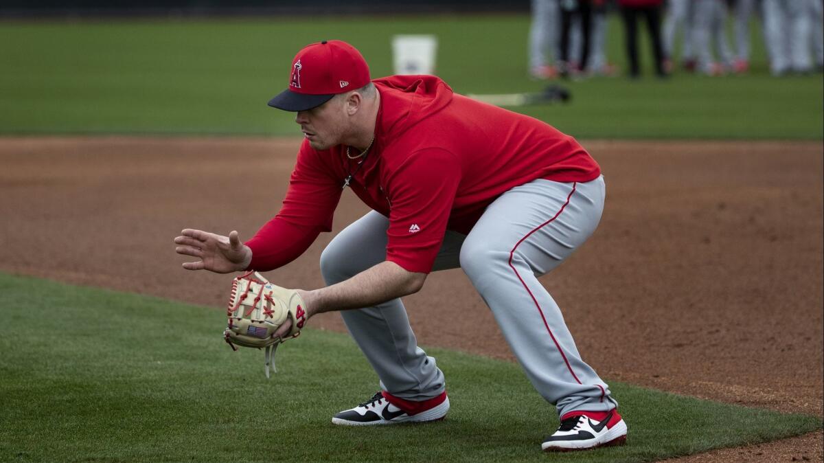 Angels first baseman Justin Bour, shown taking grounders during practice at Tempe Diablo Stadium, homered in his second at-bat of the spring.