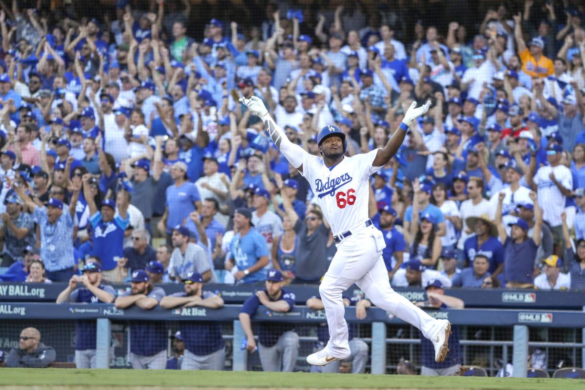 Dodgers Yasiel Puig celebrates an RBI single in the sixth inning in Game 5 of the NLCS. Robert Gauthier / Los Angeles Times