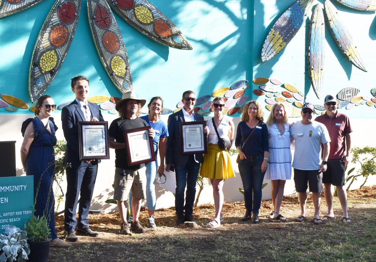 Celsey Taylor presented County proclamations to the Pacific Beach Town Council, artist Rob Tobin and Brian J. Curry.