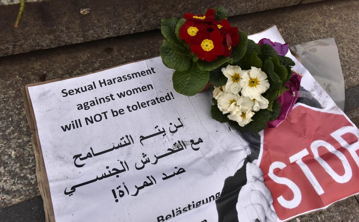 A sign left on the steps of the cathedral in Cologne, Germany, issues warnings against sexual harassment.