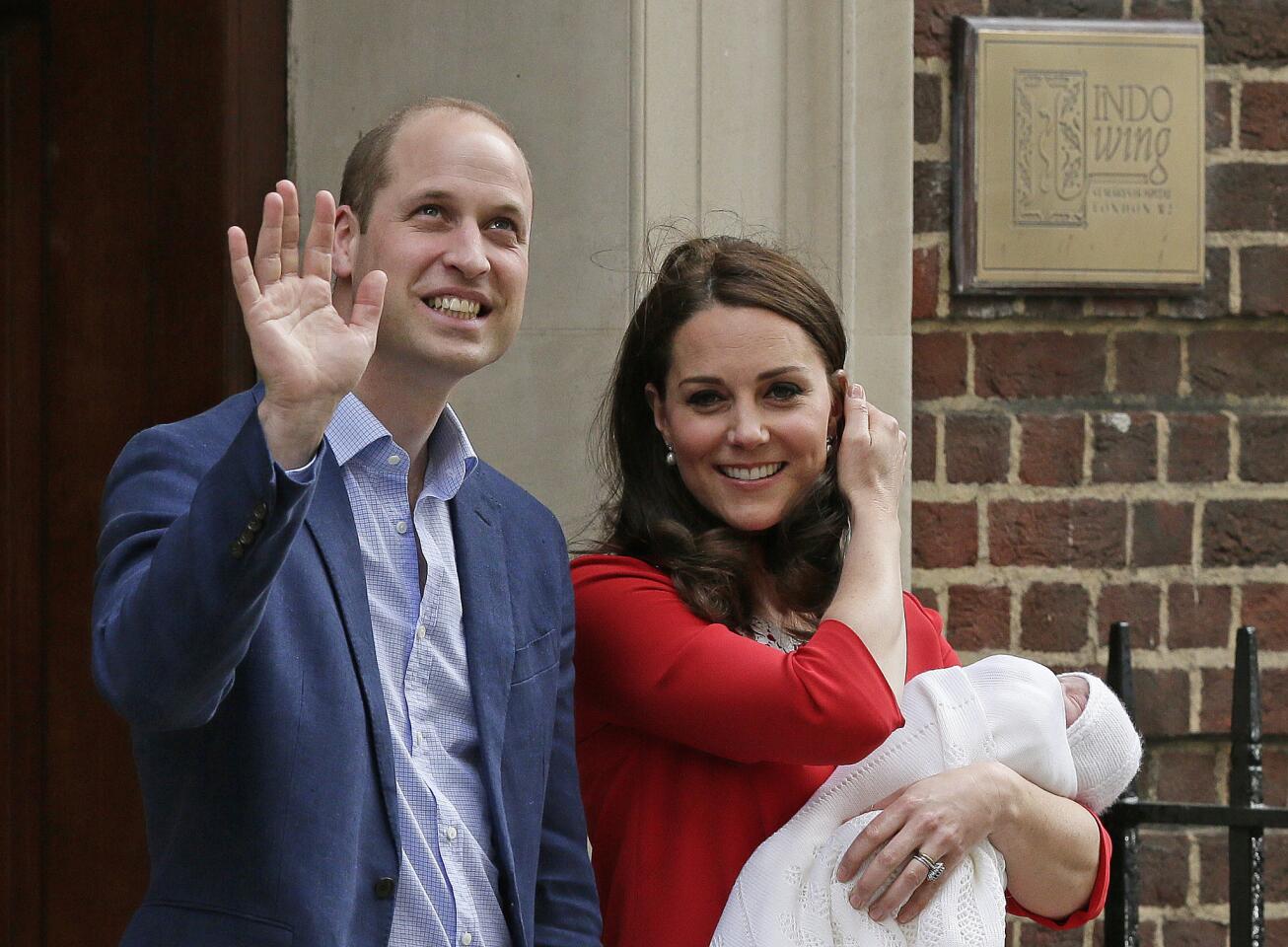 Britain's Prince William and Kate, Duchess of Cambridge wave as they hold their newborn baby son as they leave the Lindo wing at St Mary's Hospital in London London, Monday, April 23, 2018.