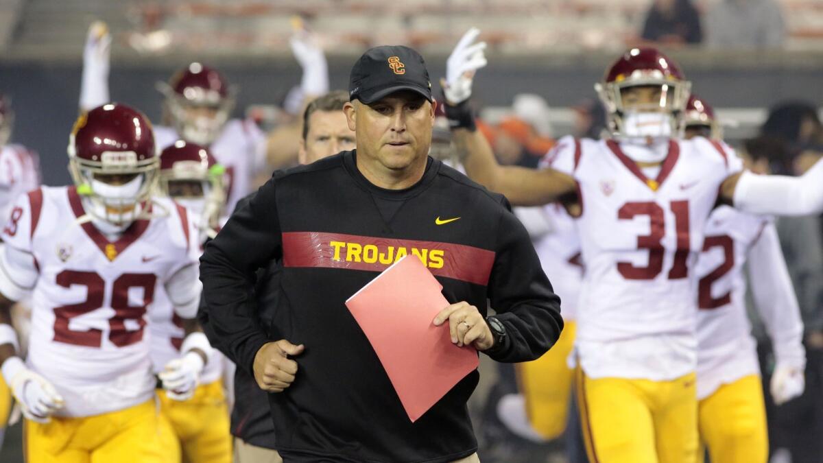 Clay Helton leads the Trojans onto the field before a Nov. 3 game against Oregon State.