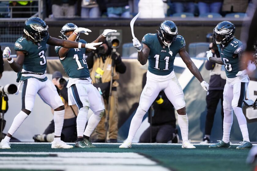 Philadelphia Eagles' A.J. Brown, second from right, celebrates his touchdown with teammates during the second half of an NFL football game against the Tennessee Titans, Sunday, Dec. 4, 2022, in Philadelphia. (AP Photo/Matt Rourke)