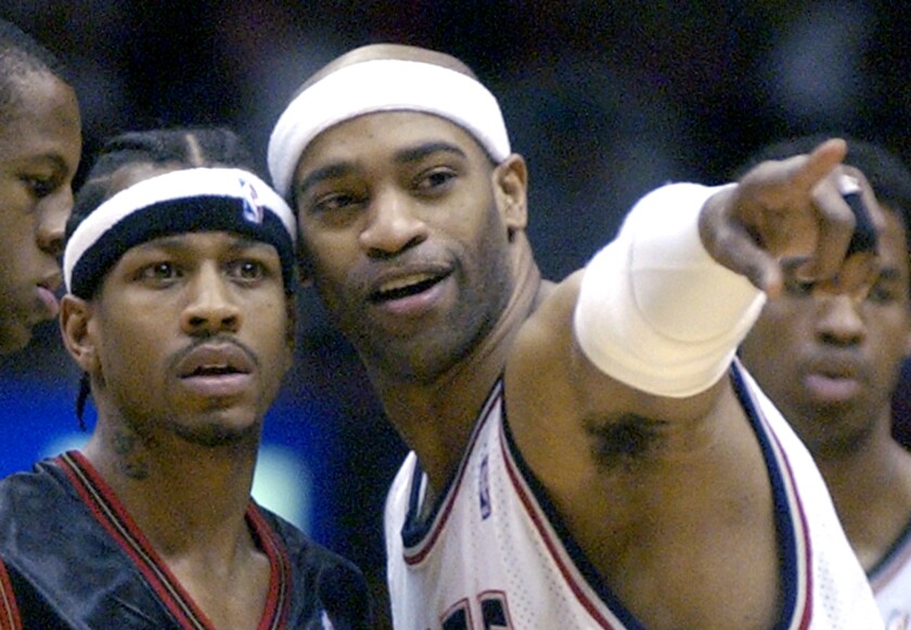 New Jersey Nets forward Vince Carter, right, points out someone to Philadelphia 76ers' Allen Iverson before a game in April 2005.