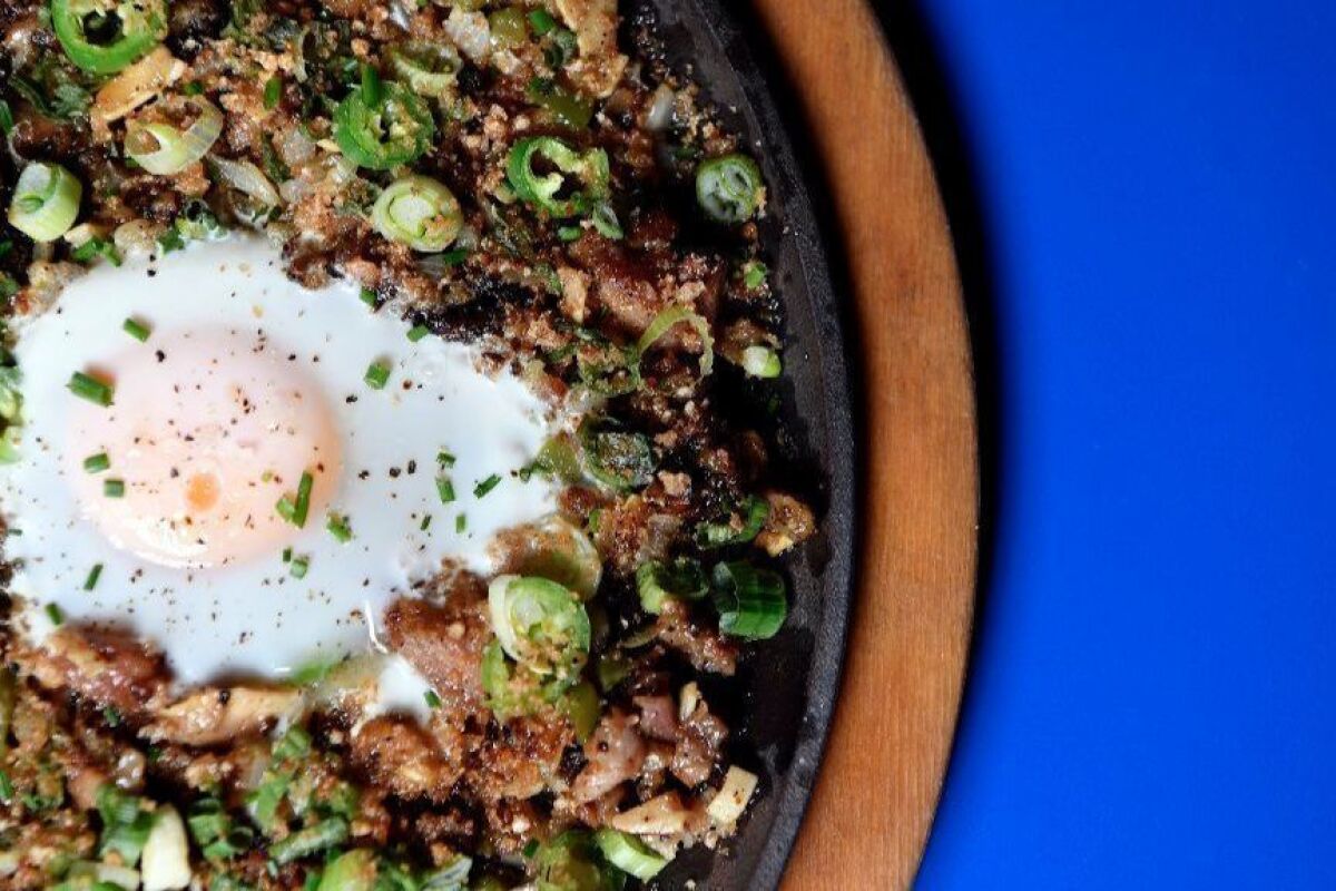 Ma'am Sir's pork sisig with egg is made with sweetbreads, Maui onion, serrano chile, green onion and calamansi.