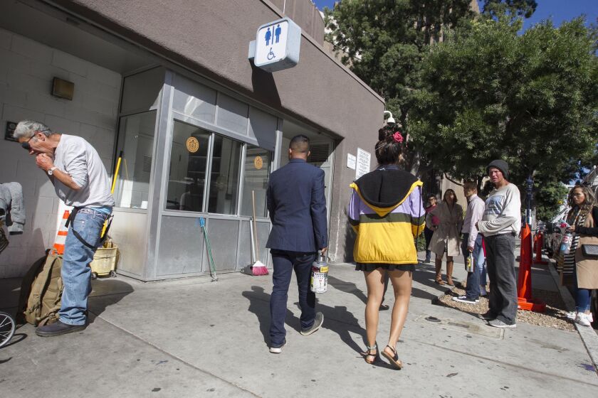 People cued up to use the public restroom at 202 C Street in downtown San Diego on Friday, October 4, 2019.