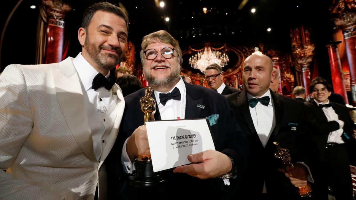 Oscars host Jimmy Kimmel, left, Oscar-winning director Guillermo Del Toro and producer J. Miles Dale of the film "The Shape of Water."