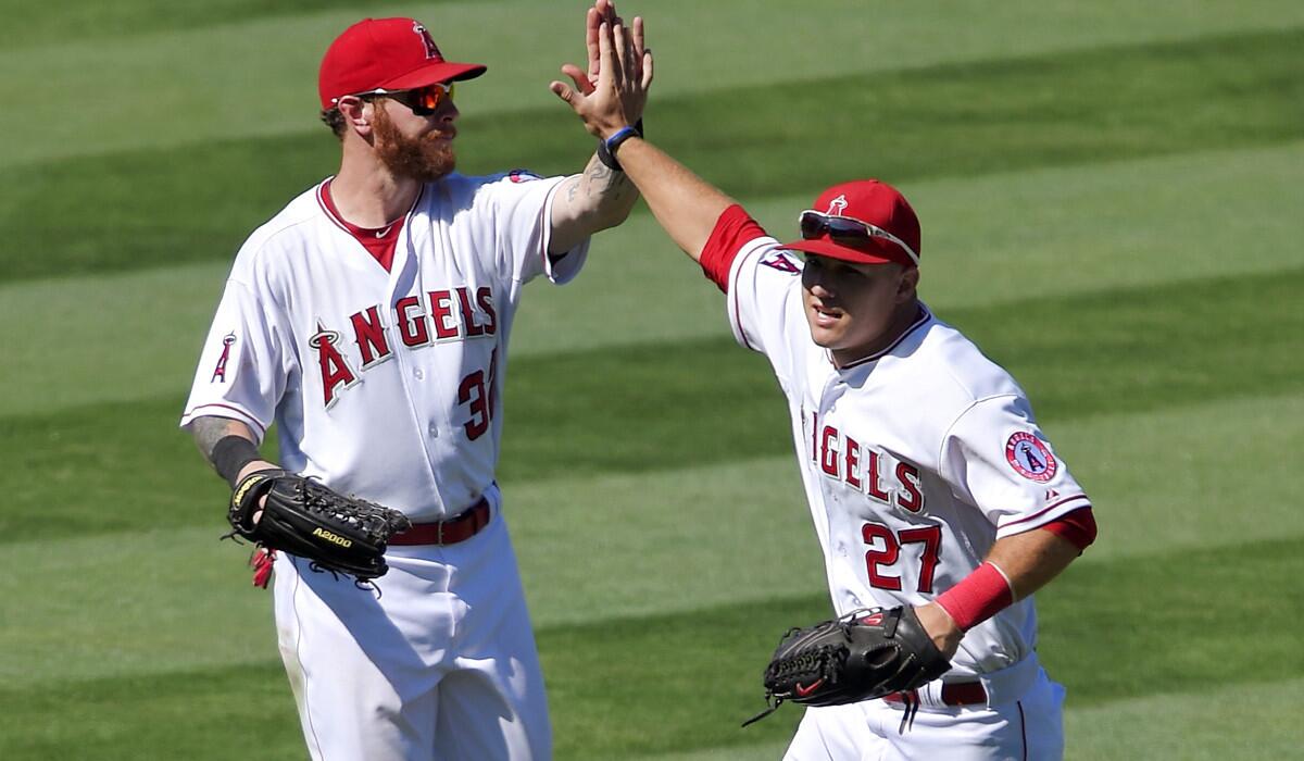 Angels outfielders Josh Hamilton (32) and Mike Trout (27) have had little to celebrate during the American League division series against the Royals.