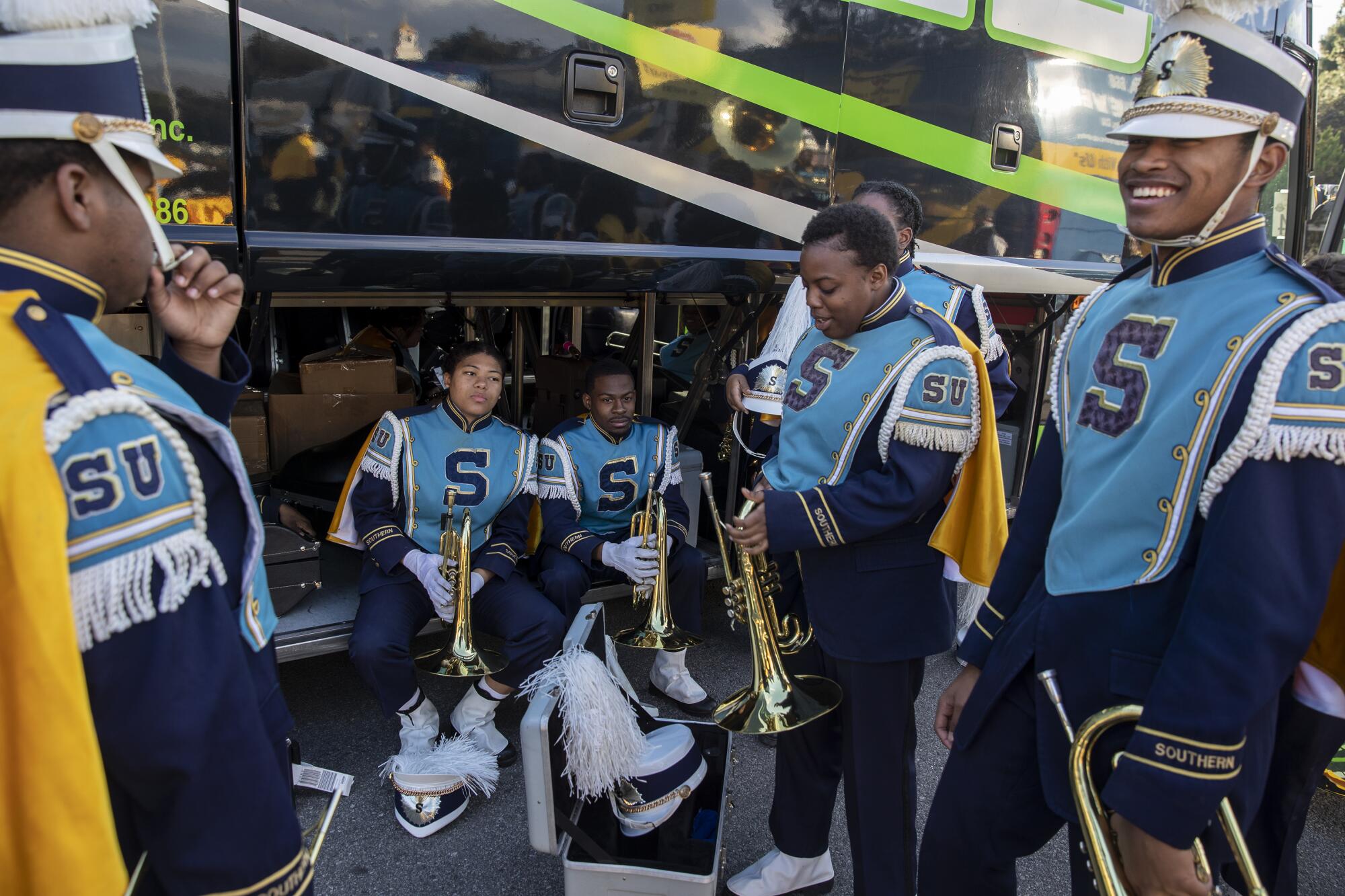 Members of the Southern University Marching Band gather their instruments at their busses for Bandfest at Pasadena City College.
