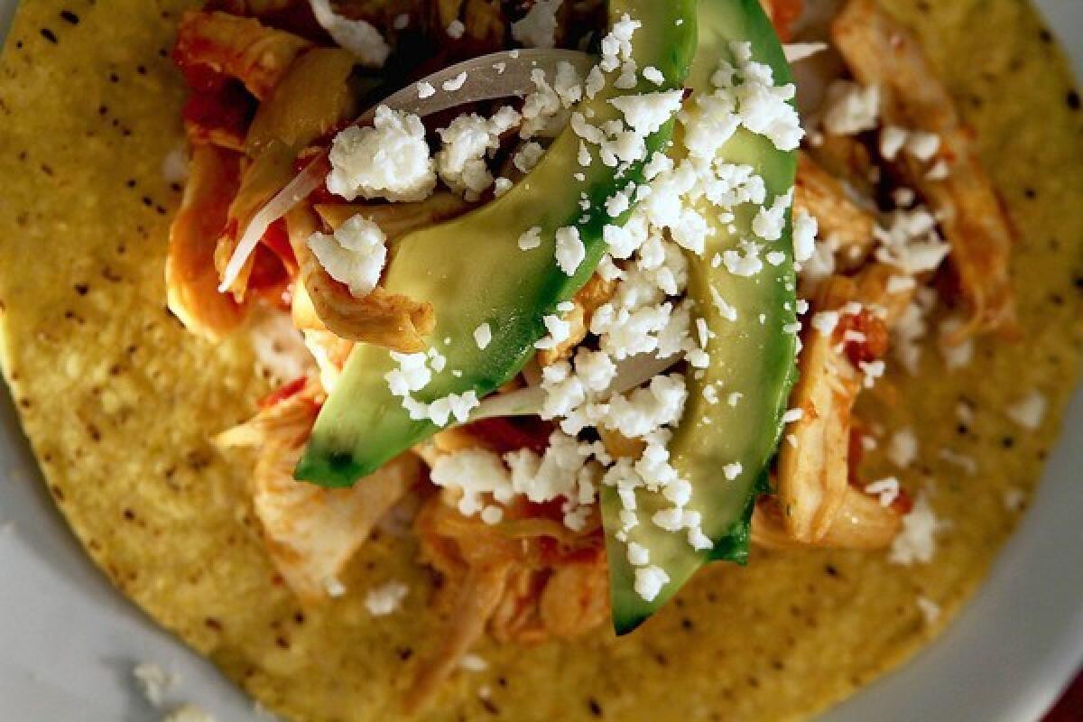 The tinga de pollo, or chicken in a chiptle-tomato sauce, is enhanced by using chipotles in a spicy-sweet pilocillo adobo.