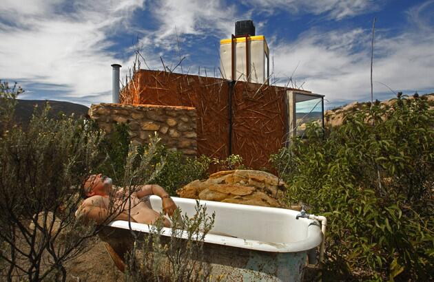D'Acosta soaks up the sun. A pipe from the raised water tank brings water to the vintage tub, which D'Acosta said allows close-up views of wildlife while bathing alfresco. "I look for eagles overhead."