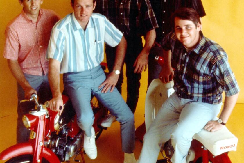 LOS ANGELES - CIRCA 1964: Rock and roll band "The Beach Boys" pose for a portrait with 2 Honda Mo-peds in circa 1964 in Los Angeles, California. (L-R) Al Jardine, Mike Love, Dennis Wilson, Brian Wilson, Carl Wilson. (Photo by Michael Ochs Archives/Getty Images)