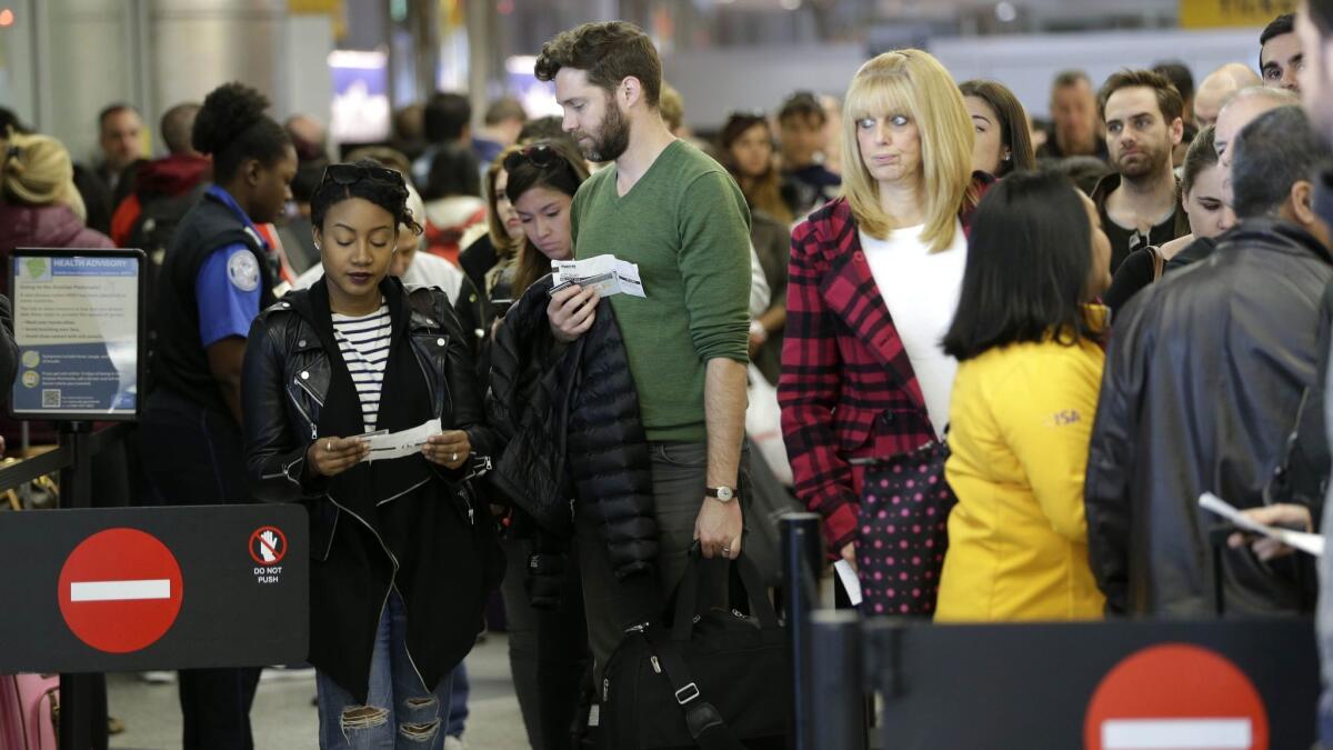 Passengers wait in a security line at LaGuardia Airport in New York on Nov. 25, 2015. AAA predicts 48.7 million Americans will travel at least 50 miles for Thanksgiving this year.