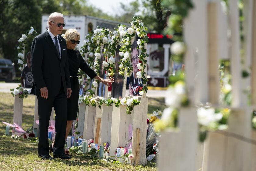 President Joe Biden and first lady Jill Biden visit a memorial at Robb Elementary School to pay their respects to the victims of the mass shooting, Sunday, May 29, 2022, in Uvalde, Texas. (AP Photo/Evan Vucci)