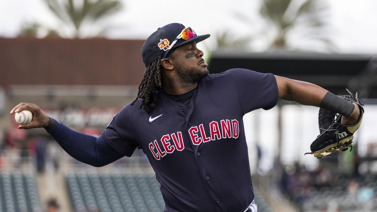 Cleveland Guardians' Josh Bell, left, and Jose Ramirez pose after