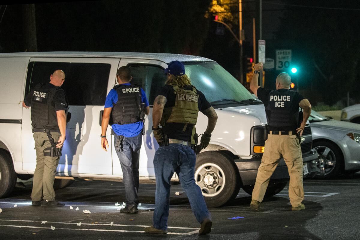 Immigration and Customs Enforcement officials raid a van