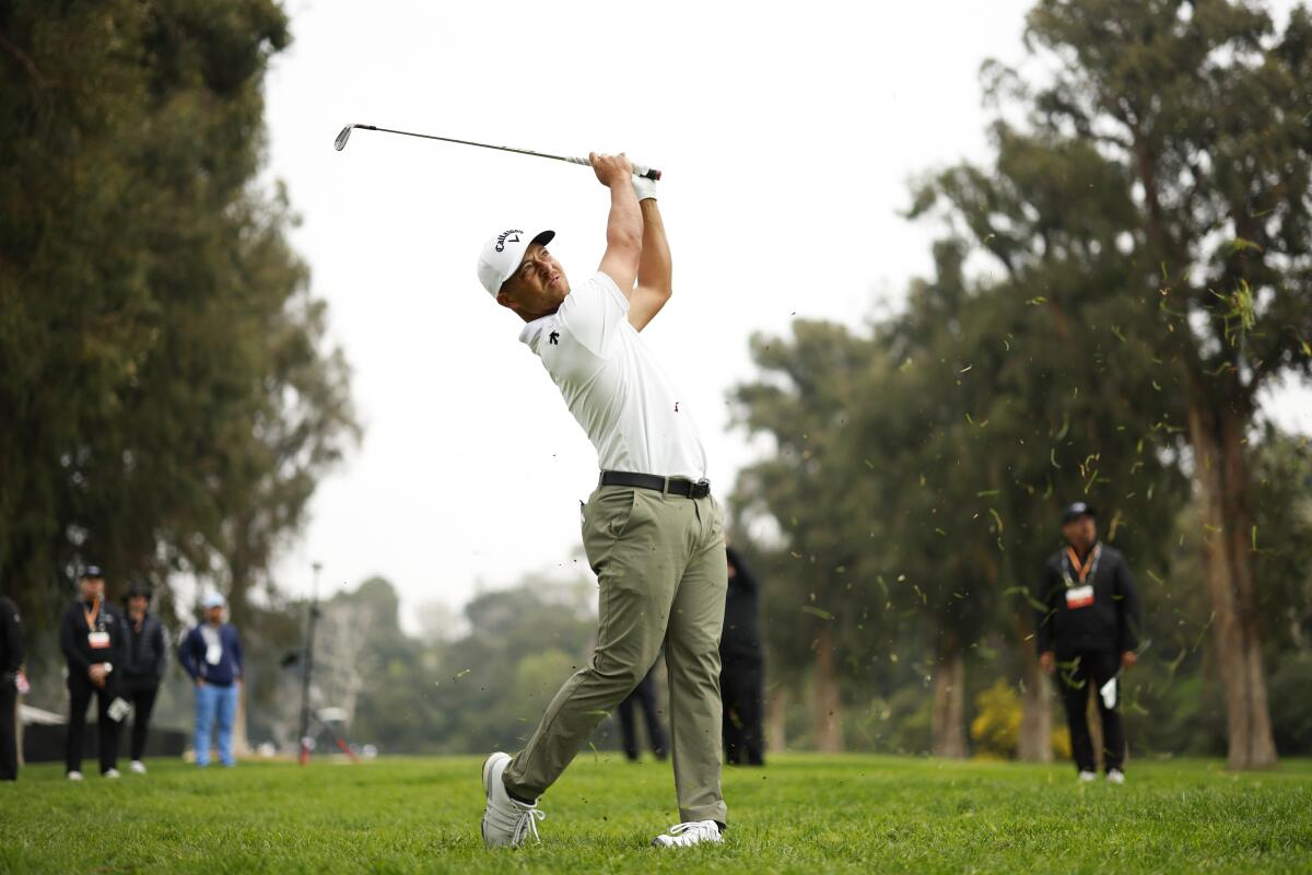 Xander Schauffele hits off the fairway rough on the 13th hole during the third round of the Genesis Invitational.
