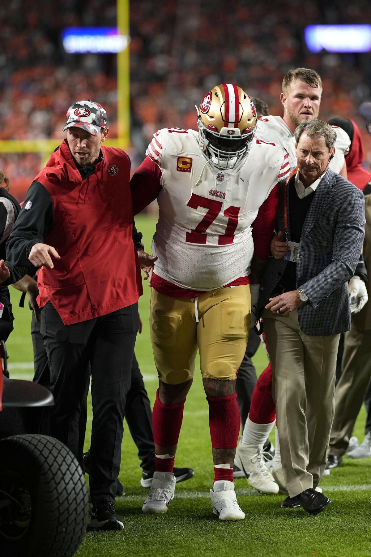 San Francisco 49ers offensive tackle Trent Williams (71) is helped off the field during the second half of an NFL football game against the Denver Broncos in Denver, Sunday, Sept. 25, 2022. (AP Photo/Jack Dempsey)