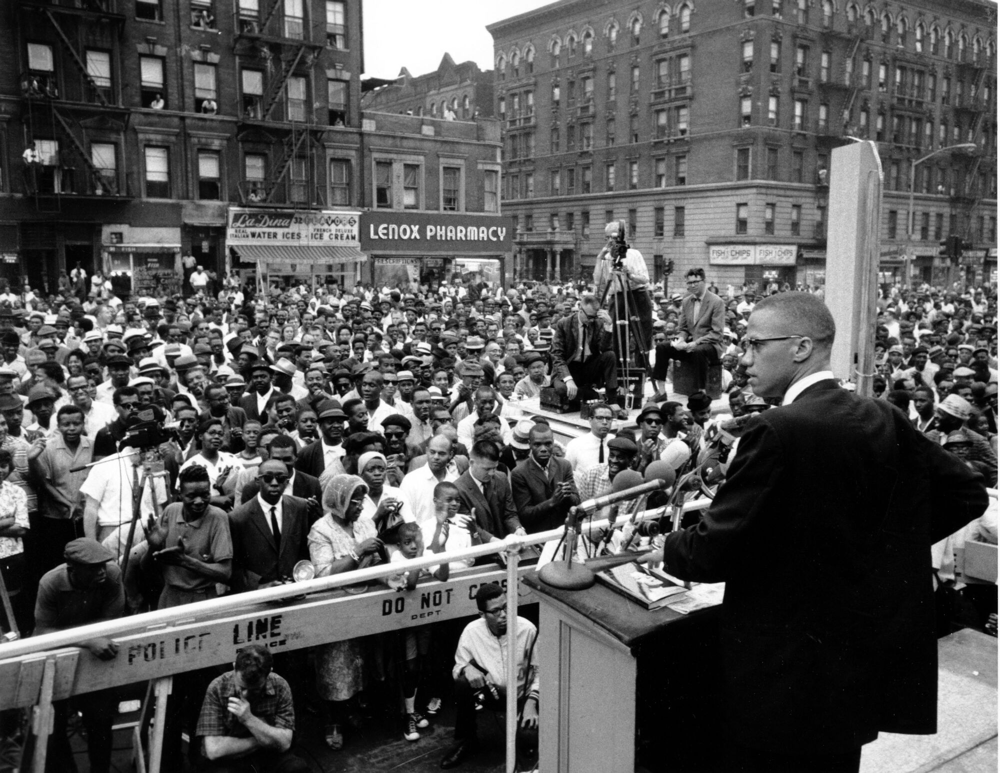 A vintage photo of a man addressing a large crowd