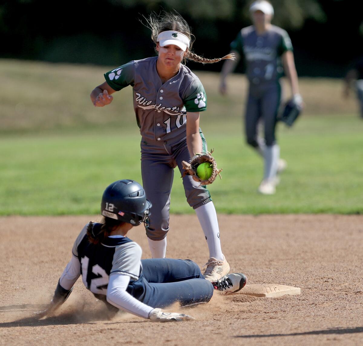 Newport Harbor's Maia Helmar (12) slides into second safely under the tag of Twentynine Palms' Hailee Jenkins (10).