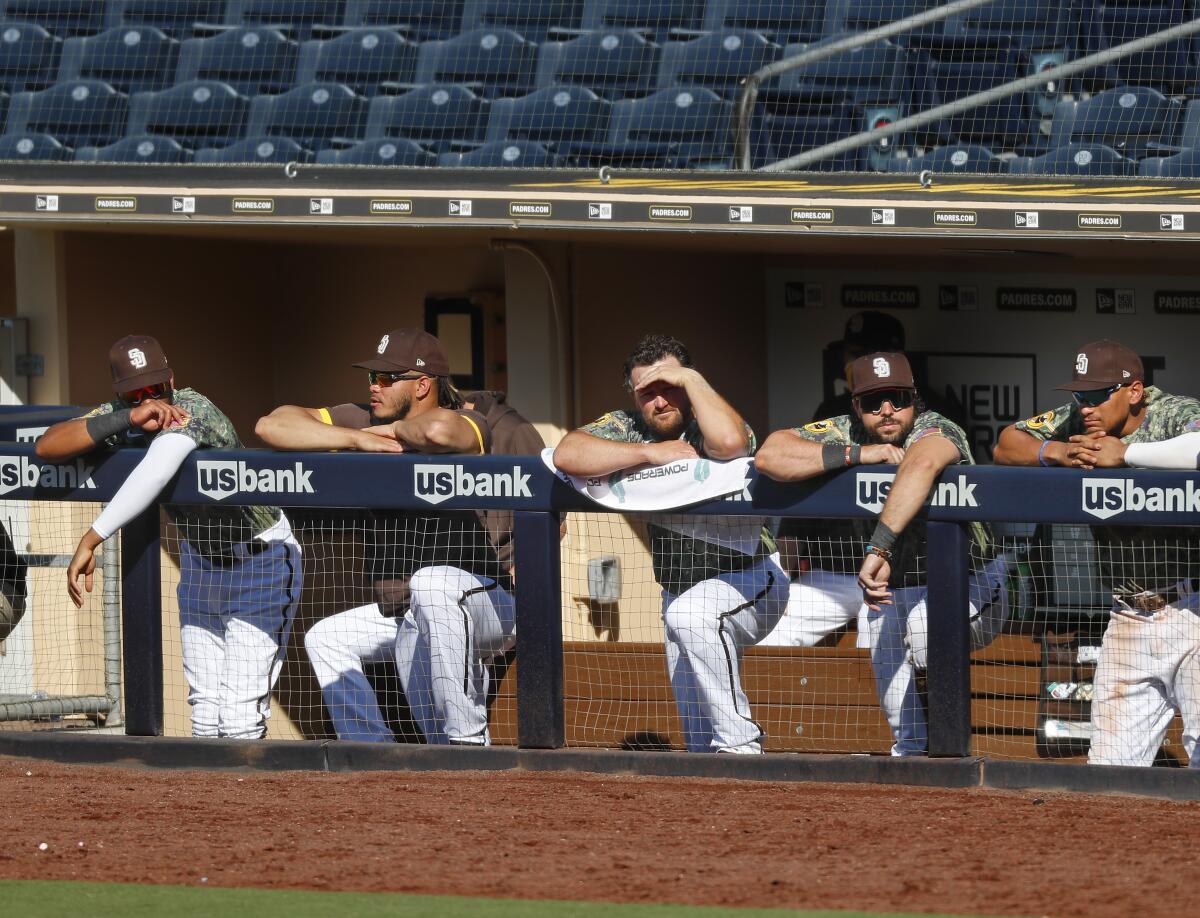 The San Diego Union-Tribune - The Padres' Manny Machado, left, Fernando  Tatis Jr., center, and Eric Hosmer, wear the Padres new brown uniforms  after they stood on stage to show fans during