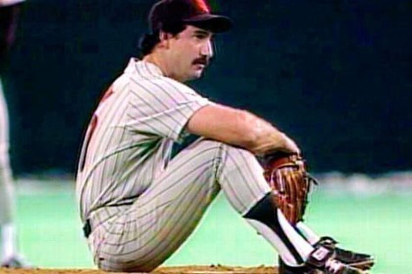 Padres pitcher Eric Show sat on the mound after giving up Pete Rose's record-breaking hit on Sept. 11, 1985.