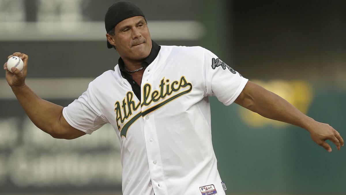 Jose Canseco throws out the ceremonial first pitch prior to an Oakland Athletics game against the Boston Red Sox on Sept. 3, 2016.