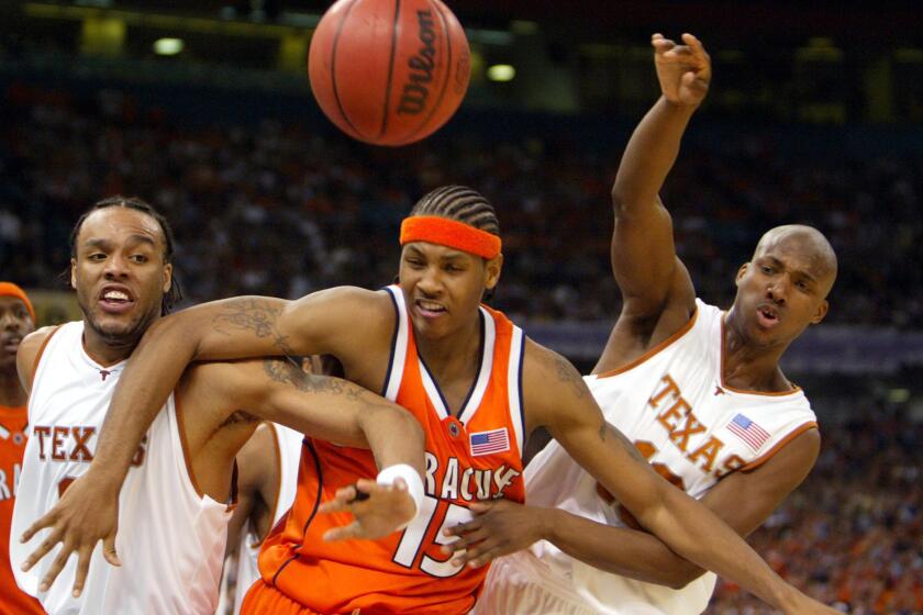 Carmelo Anthony fights for rebounding position against Texas' James Thomas, left, and Sydmill Harris during Syracuse's Final Four victory on April 5, 2003, in New Orleans.