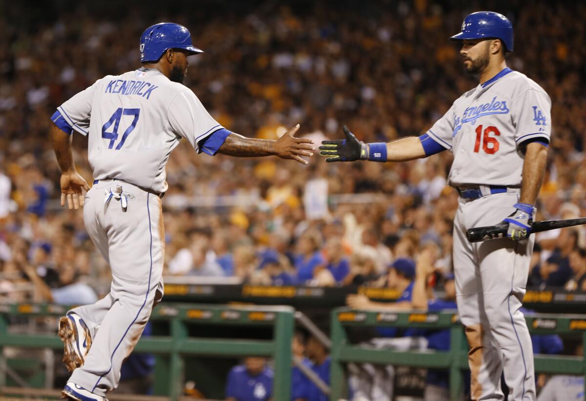 Dodgers second baseman Howie Kendrick (47) is greeted by teammate Andre Ethier after scoring on a hit by Adrian Gonzalez in the third inning Sunday in Pittsburgh.