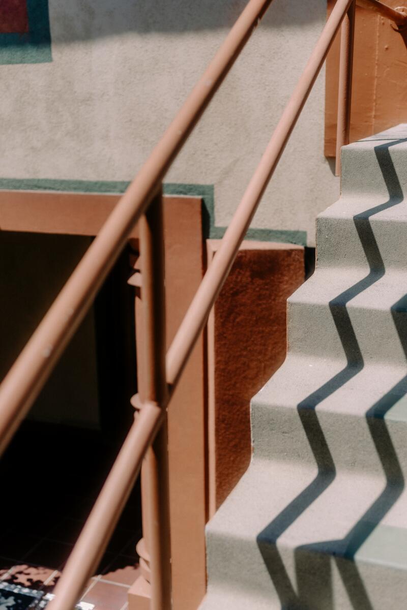 A set of stairs, with angular shadows cast upon them in the afternoon light.