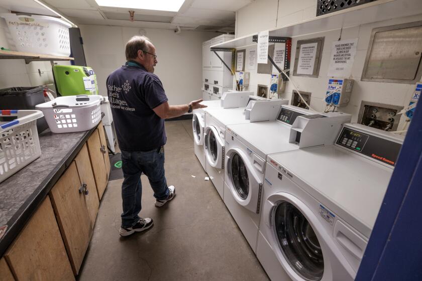 SAN DIEGO, CA - FEBRUARY 09, 2023: Paul Sheck, program manager for the Neil Good Day Center, walks into a laundry room where clients, who are mostly homeless, can wash their clothes at the Neil Good Day Center in San Diego on Thursday, February 09, 2023. (Hayne Palmour IV / For The San Diego Union-Tribune)