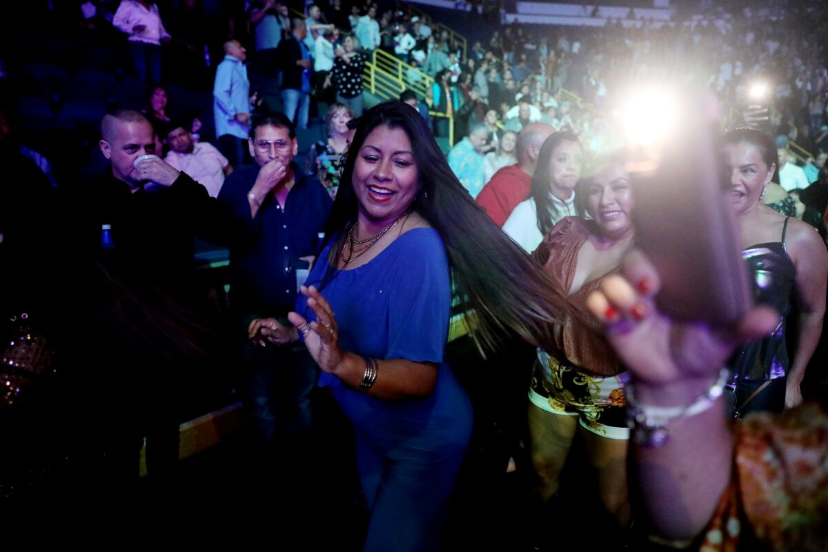 Fans dance in the walkways as Los Ángeles Azules performs