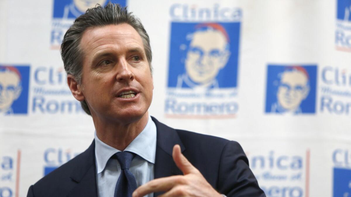 Gov. Gavin Newsom speaks last week at L.A.'s Clinica Monseñor Oscar A. Romero healthcare facility about Central American migration and his upcoming visit to El Salvador.