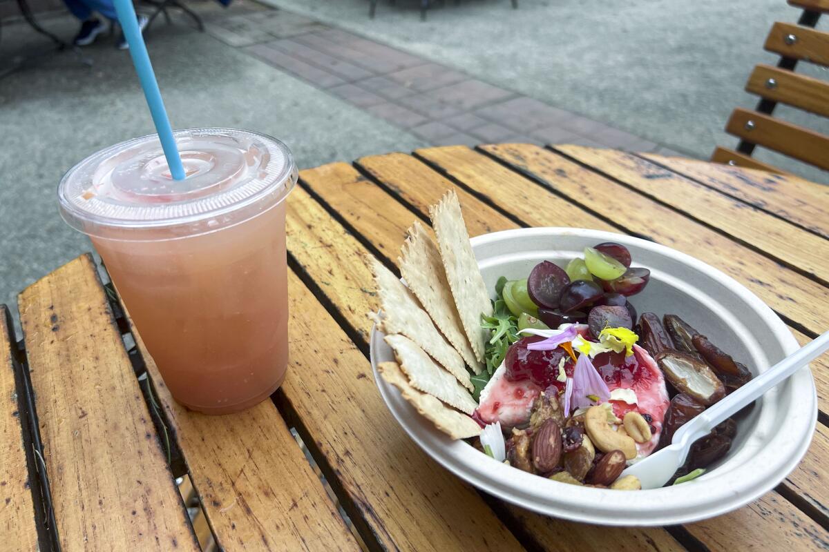 Purple haze goat cheese plate and house-made hibiscus lemonade on a wooden table