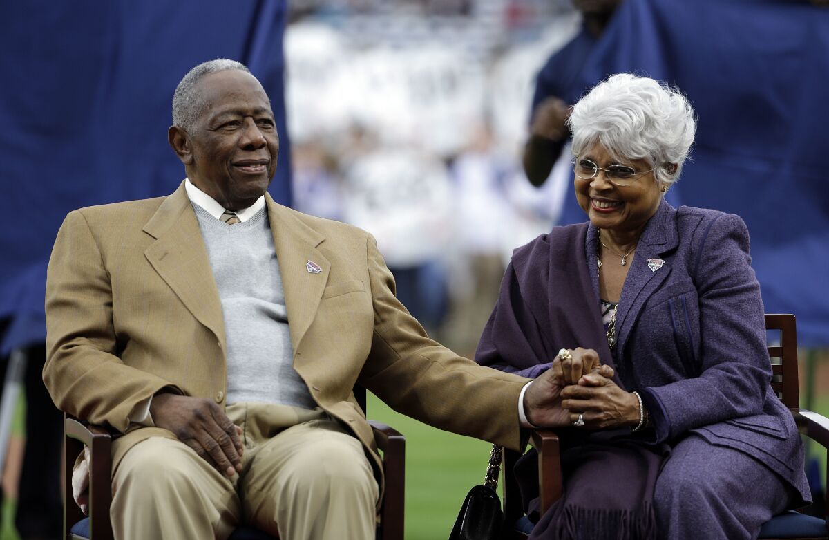 Hank Aaron sits with his wife, Billye, during a 2014 ceremony celebrating the 40th anniversary of his 715th home run.