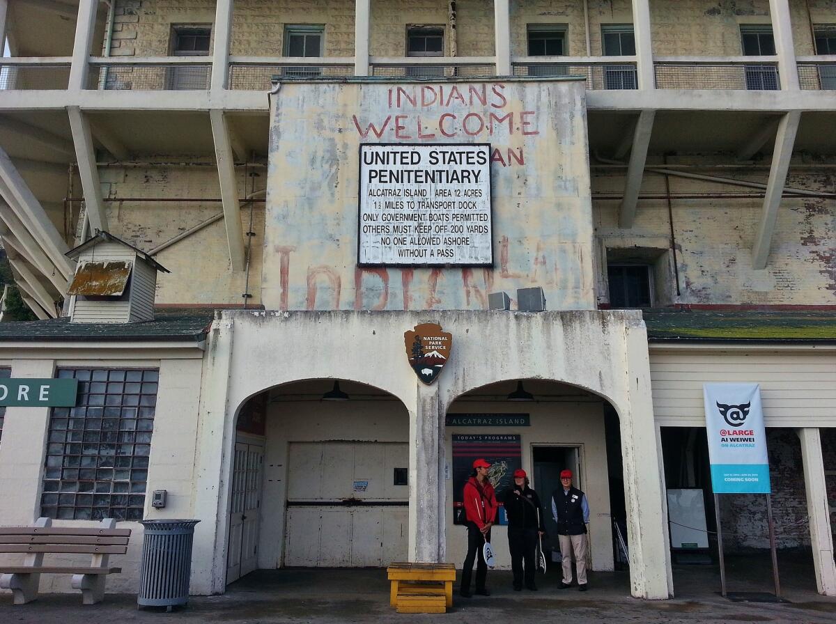 Over the Alcatraz landing, a sign that says "Indians Welcome"