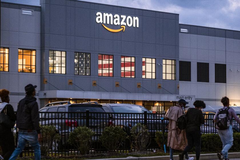 FILE - People arrive for work at the Amazon distribution center in the Staten Island borough of New York, on Oct. 25, 2021. Amazon plans to file objections to the union election on Staten Island, N.Y., that resulted in the first successful U.S. organizing effort in the company’s history. The e-commerce giant stated its plans in a legal filing to the National Labor Relations Board made public Thursday, April 7, 2022. (AP Photo/Craig Ruttle, File)