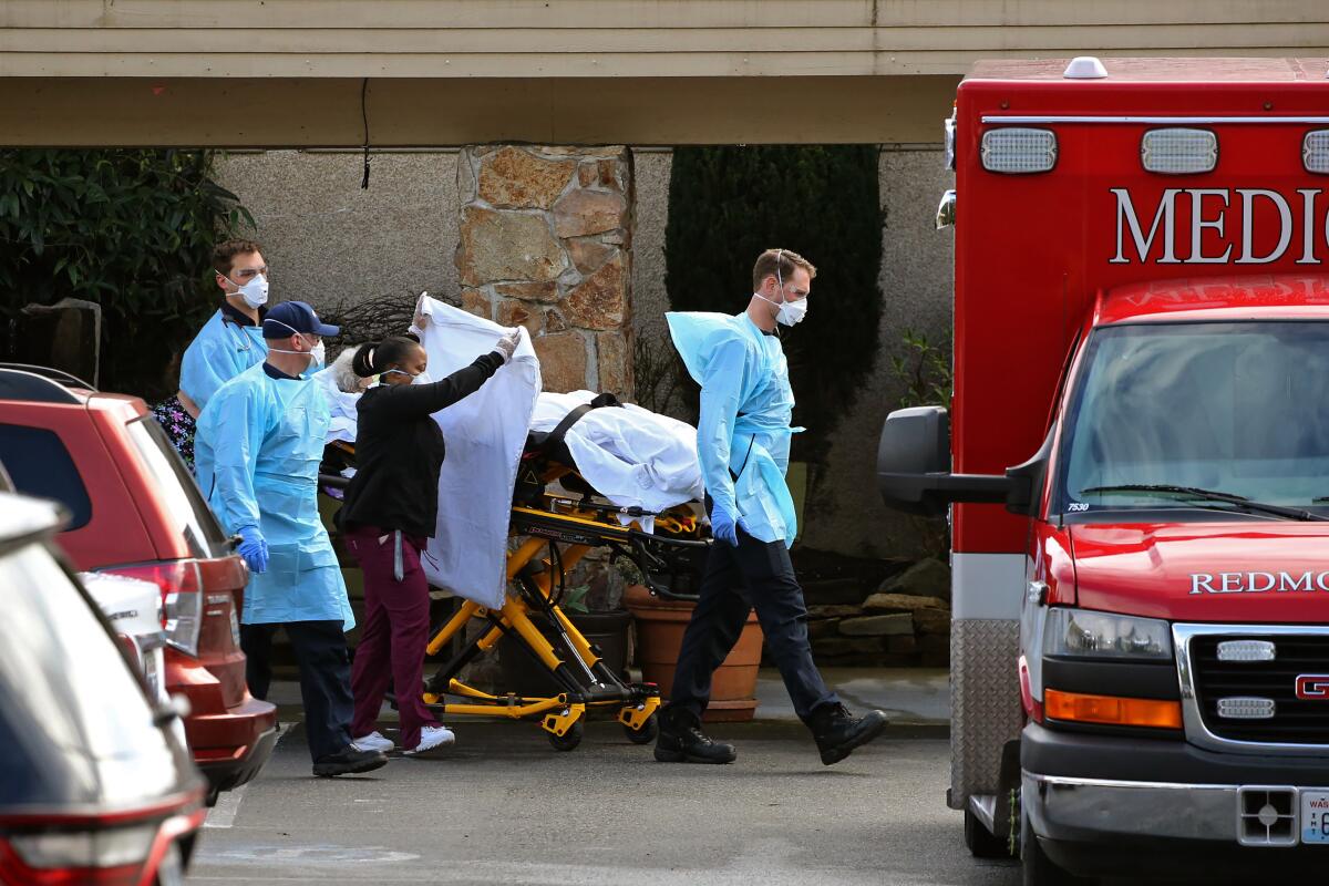 A patient at the Life Care Center in Kirkland, Wash., is transferred into an ambulance Saturday.